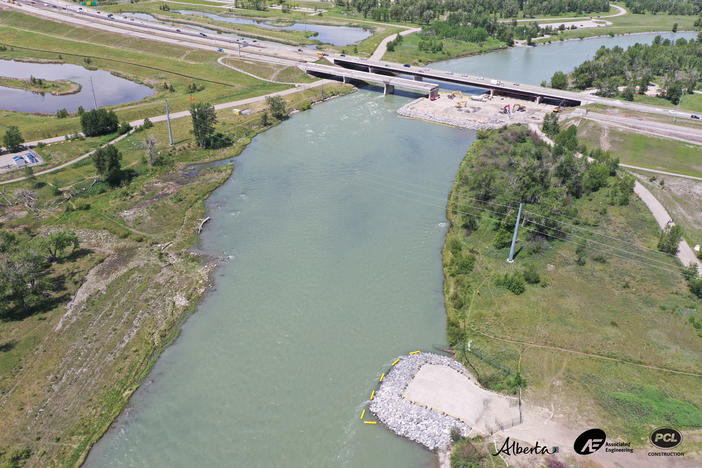 Looking north with completed east berm of pedestrian bridge in forefront, and Stoney Trail bridge in the background.