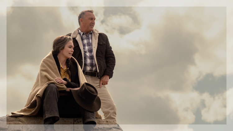 Man standing next to a woman sitting on a rock in a scene from Let Him Go