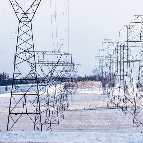 Powerlines running across a snowy field