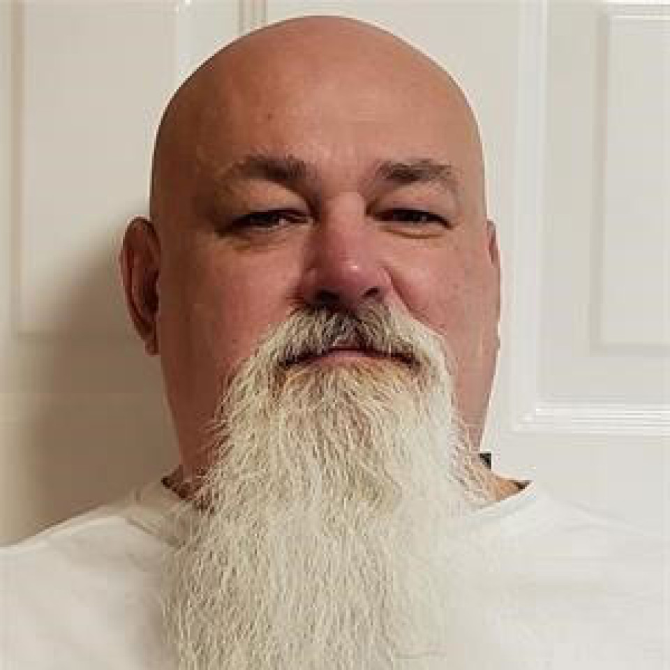 Dwain Law: male, bald, blue eyes, white moustache and beard