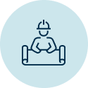 A person sitting at a table wearing a hard hat.
