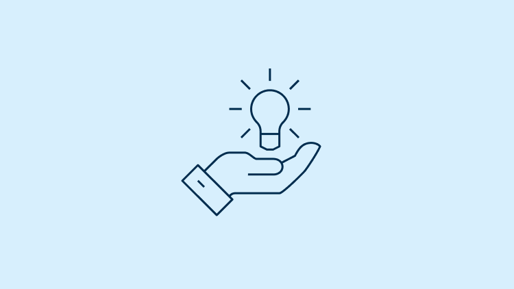 A hand holding a light bulb.