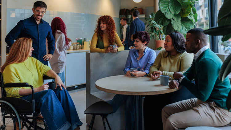 Group of people gathered around a small round table