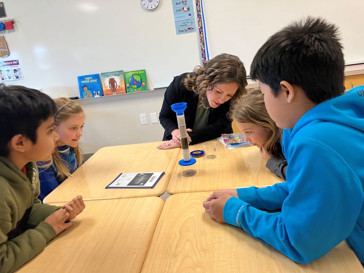 Minister Schulz participating in a water monitoring lesson with Grade 4 students from A.E. Bowers Elementary School