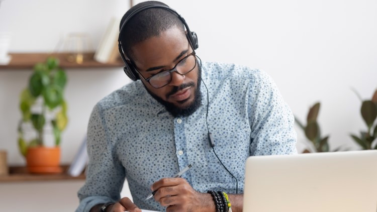 image of a man with headphone and laptop