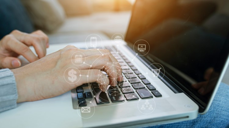 Image of woman's hands on a laptop