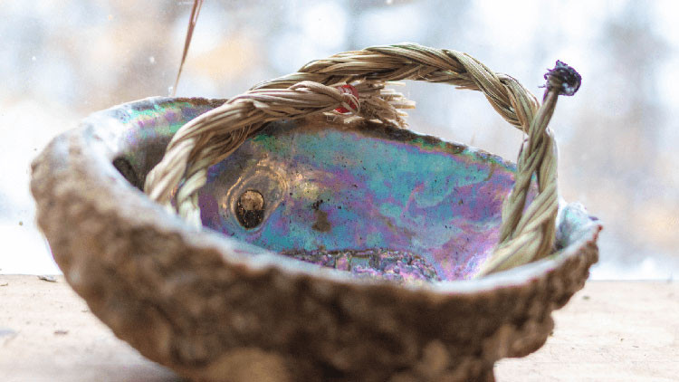 Iridescent oyster shell used as a bowl with twine inside
