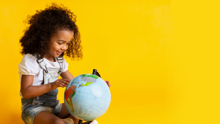Young girl holding a small globe