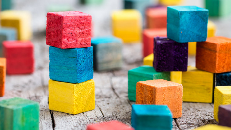 Close up of various coloured square wooden blocks