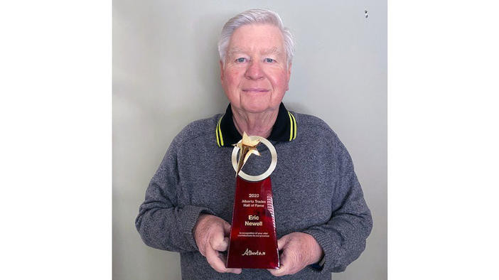 A photo of Eric Newell with his award.