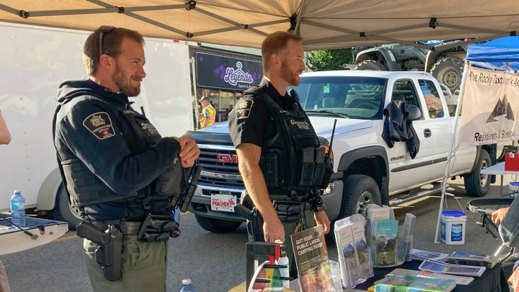 image of 2 conservation officers standing at a display