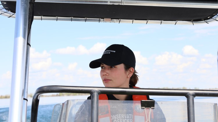 image of conservation officer in boat