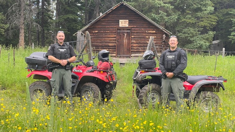 image of 2 Conservation officers standing by their quads