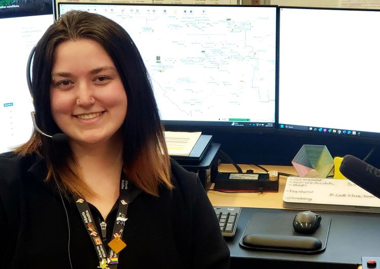 Julia is a dispatcher with AB wildfire and is sitting in front of her monitors and radio microphone