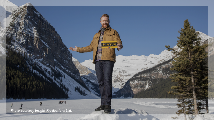 Host Joe Montgomery from the tv show Amazing Race with Lake Louise Alberta in the background.