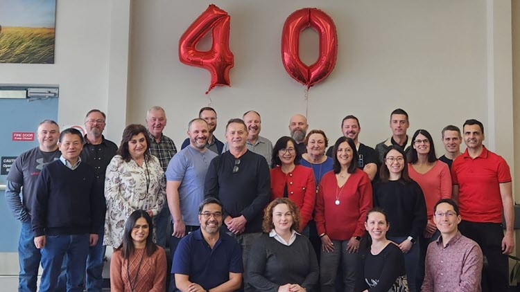 Group photo of Alberta’s Food Processing Development Centre staff with red 40 balloon behind