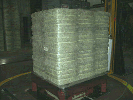 Photo of Wrapped compressed bales, waiting to be loaded into a container for shipping