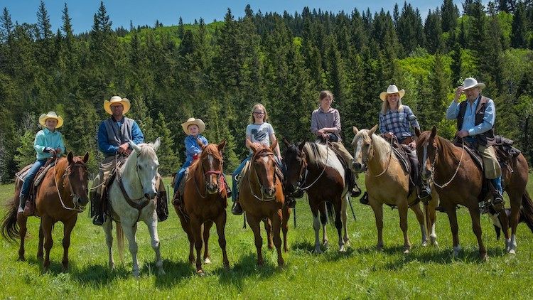 Seven members of the Burton-Wachtler family sitting on horses