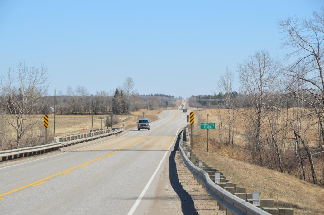Single lane highway near Medicine River looking east.