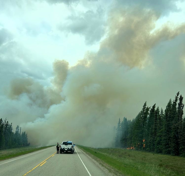 Large column of smoke over highway