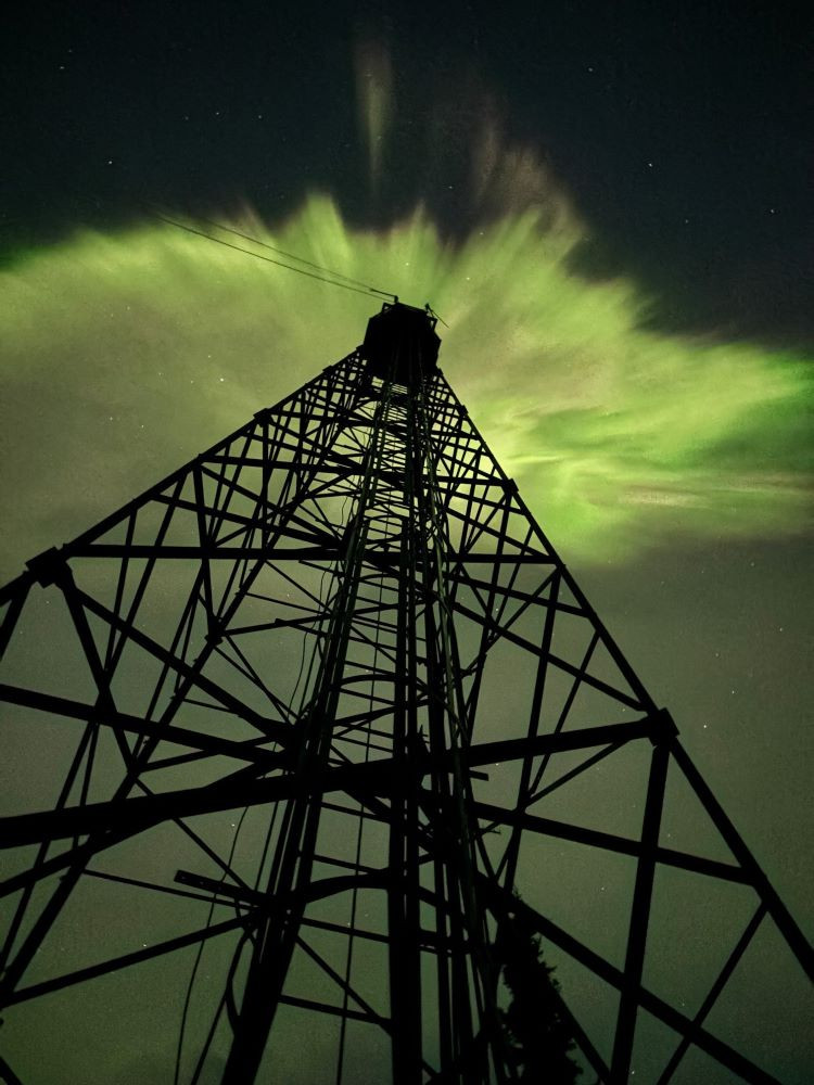 Northern lights above a lookout tower