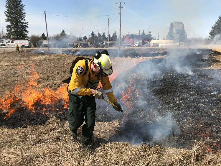firefighter burning grass