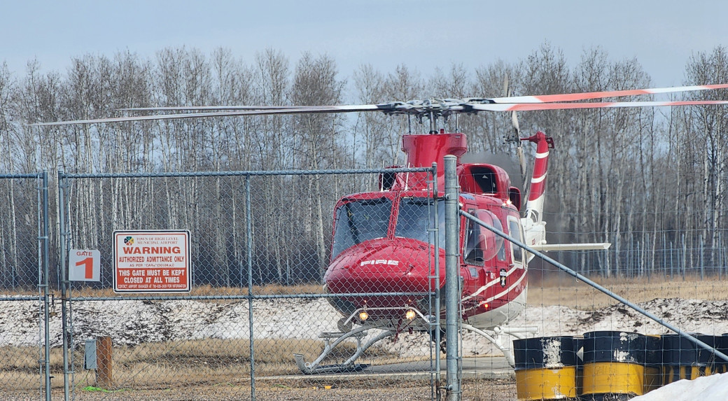  A red helicopter prepares to take-off from the landing zone (LZ) across from the High Level Forest Area Fire Centre