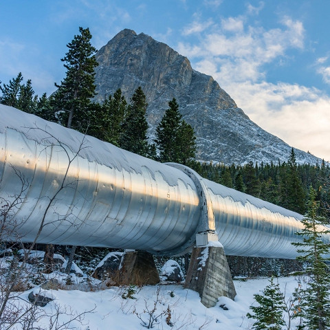 Pipeline running through the Rocky Mountains on a winter day