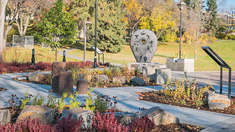 Alberta reconciliation garden - colourful plants and trees with monument