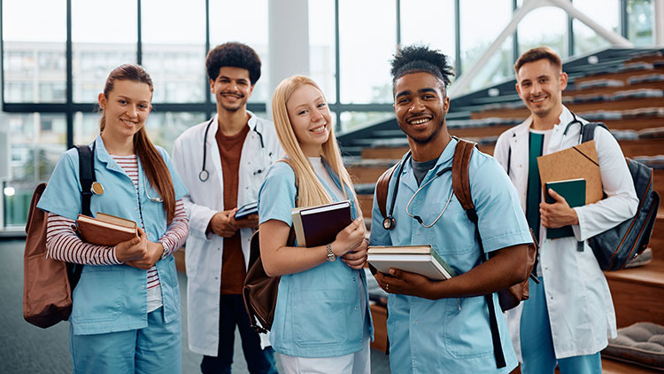 Image of 5 medical students smiling at camera.