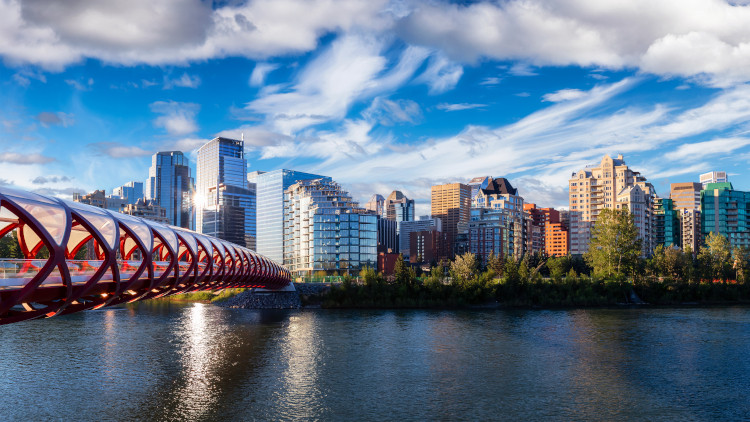 The Peace Bridge spanning across the Bow River, with Downtown Calgary visible on the far side