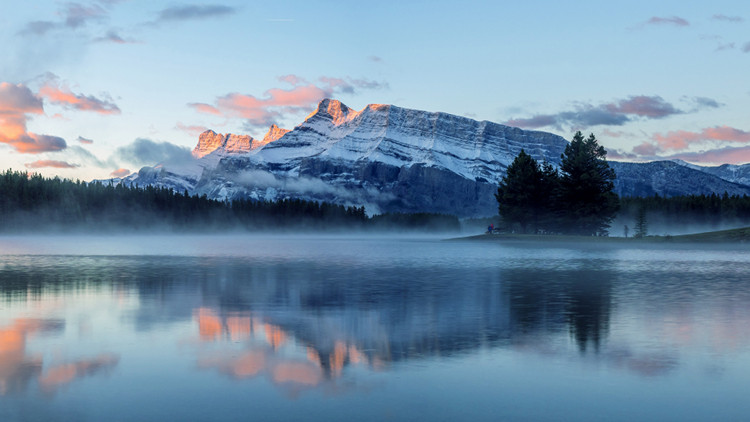A mountain rises against a sunrise in Jasper National Park