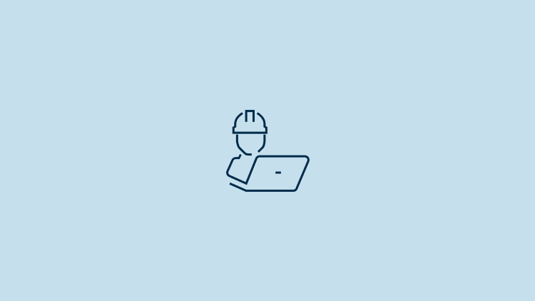 Icon of a man with a construction hat working on a laptop.