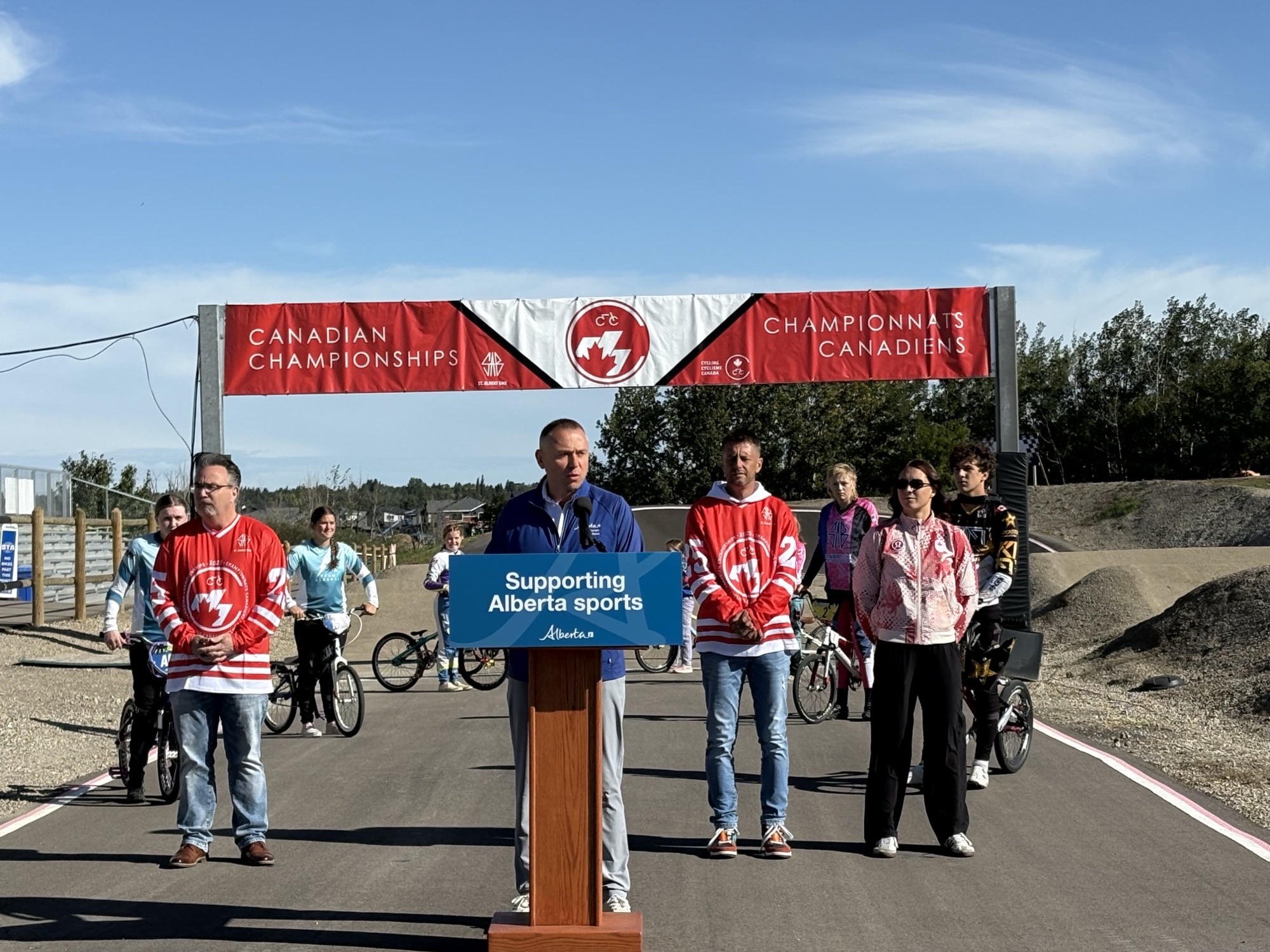 (L-R) MLA St. Albert – Morinville, Dale Nally; Andrew Boitchenko, Minister of Tourism and Sport;  Kyle Reiling, President, St. Albert BMX Club and Molly Simpson, Olympic BMX cyclist at the St. Albert BMX track